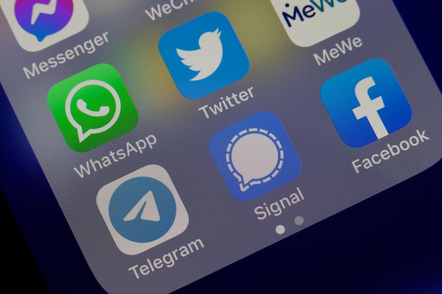 In this photo illustration, the logos of social media applications Messenger, WhatsApp, Twitter, MeWe, Telegram, Signal and Facebook are displayed on the screen of an iPhone on January 13, 2021 in Paris, France.