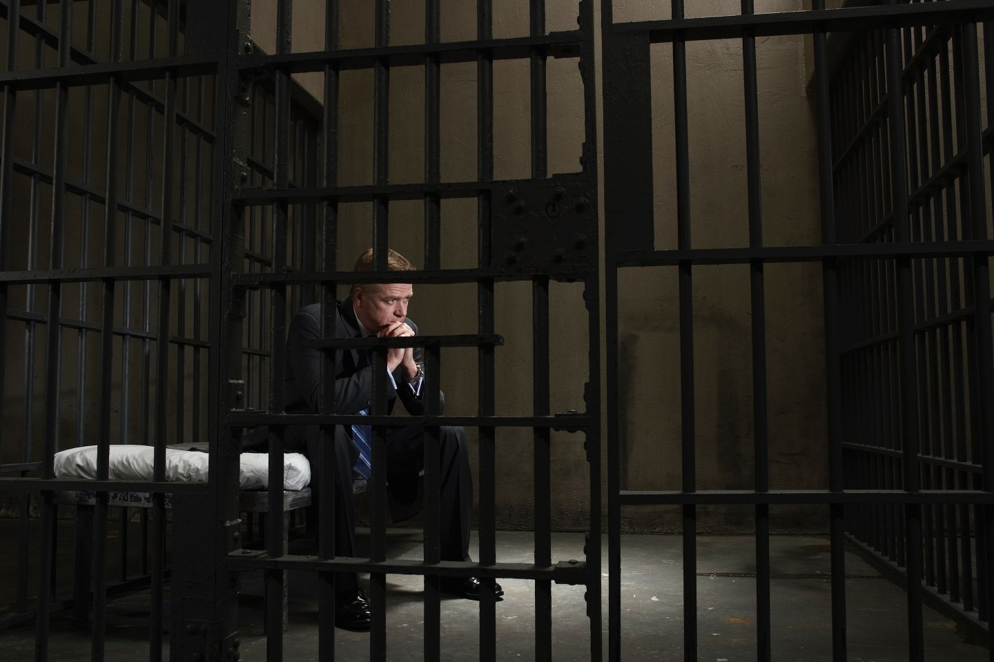 man sits in jail cell