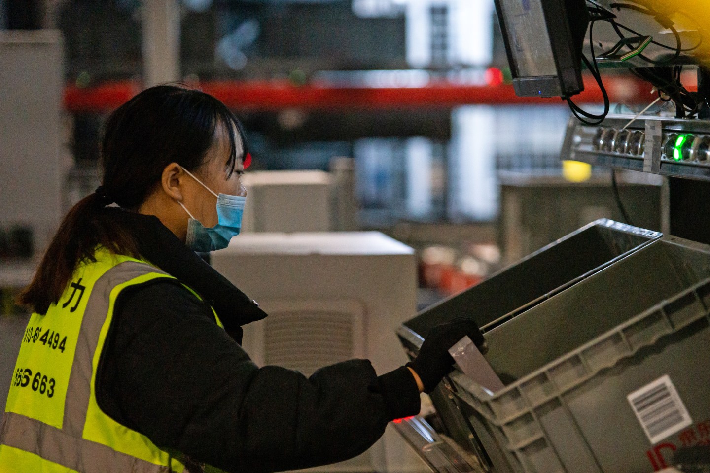 A woman works at the Jingdong logistics centre in southern Beijing, one of the largest in Asia, with its automated sorting equipment capable of processing up to 800,000 packages per day, and customers waiting no longer than a day for their orders to arrive. Jingdong is the leading Chinese e-commerce platform.