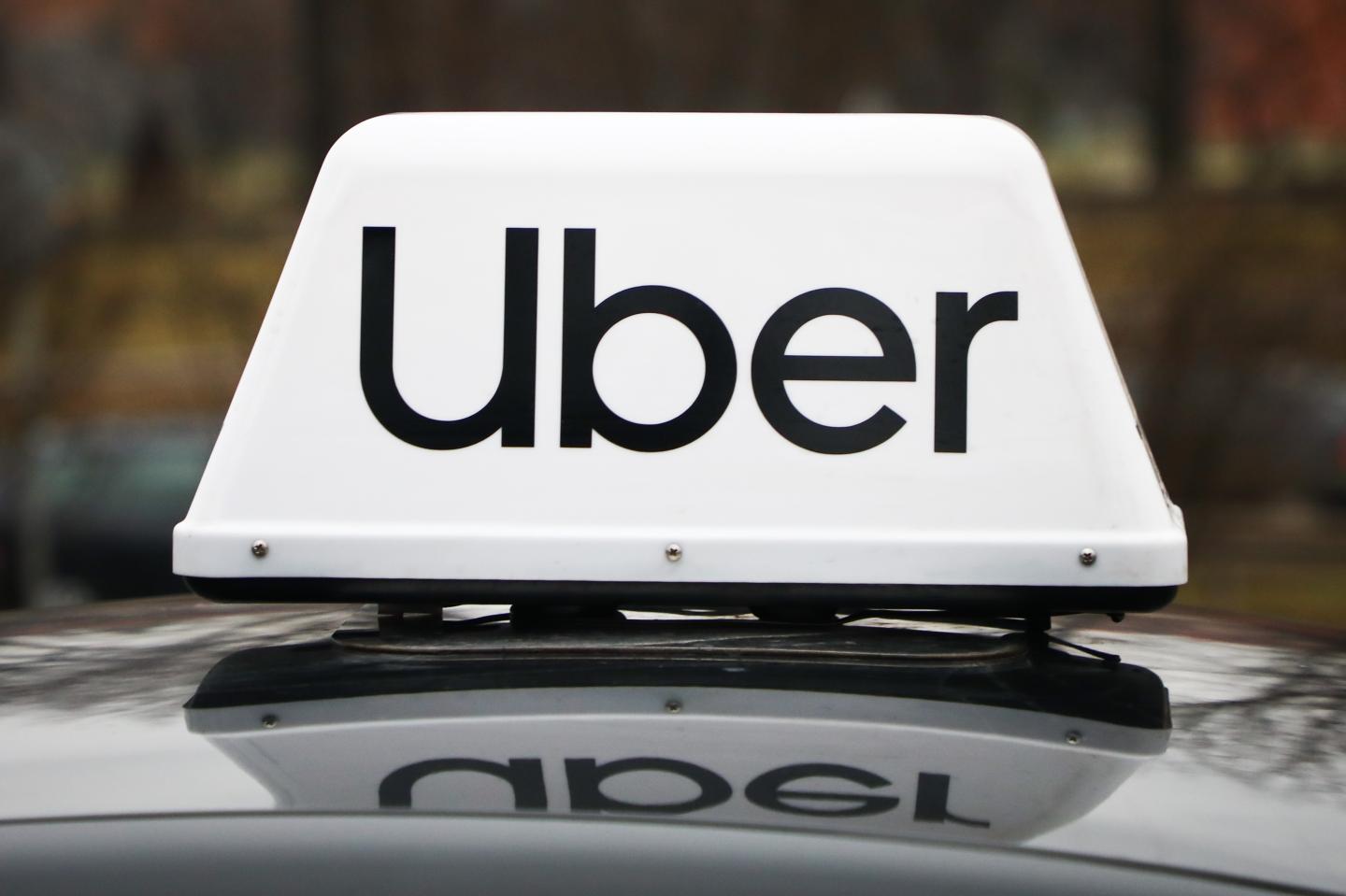 Logo of Uber taxi car is pictured outdoors in Krakow, Poland, on February 5, 2021.