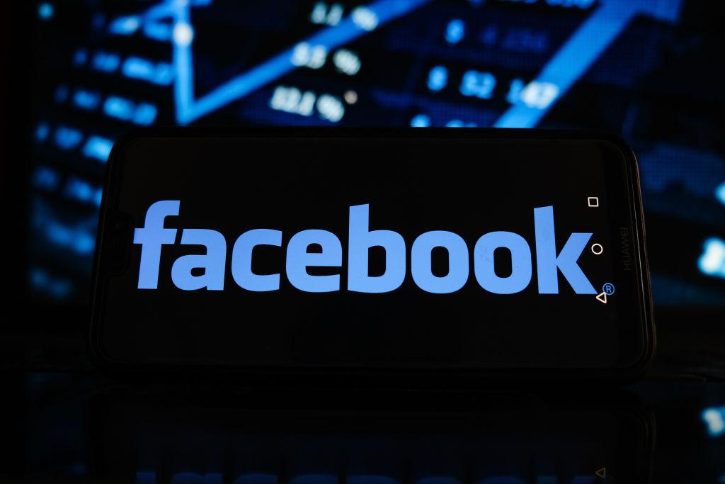 In this photo illustration a Facebook logo seen displayed on