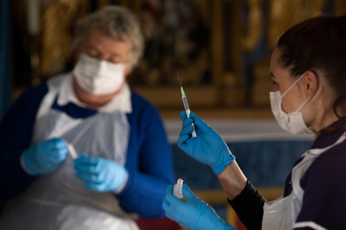 Covid-19 injections are prepared before patients get their jabs at a vaccination centre at Salisbury Cathedral on February 11, 2021 in Salisbury, England.