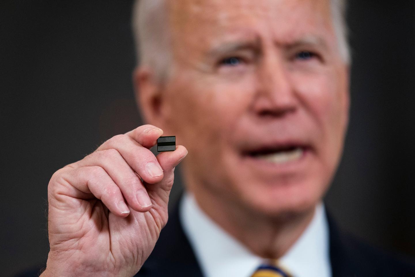 U.S. President Joe Biden holds a semiconductor during his remarks before signing an Executive Order on the economy in the State Dining Room of the White House on February 24, 2021 in Washington, DC.