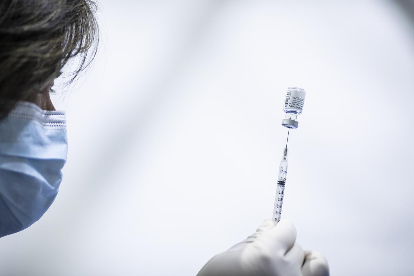 With billions spent and ‘wartime’ declared, why are vaccines still in short supply?