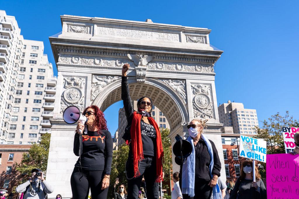 A protester speaks through a megaphone to the crowd at