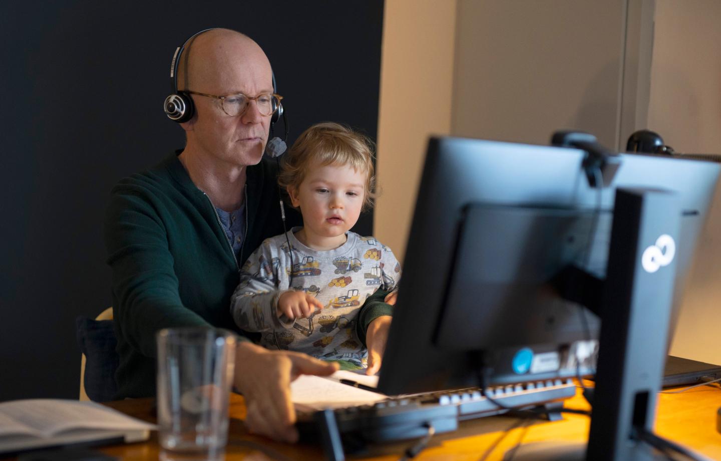 In this photo illustration a man with toddler at desk doing homeoffice on January 14, 2021 in Bonn, Germany.