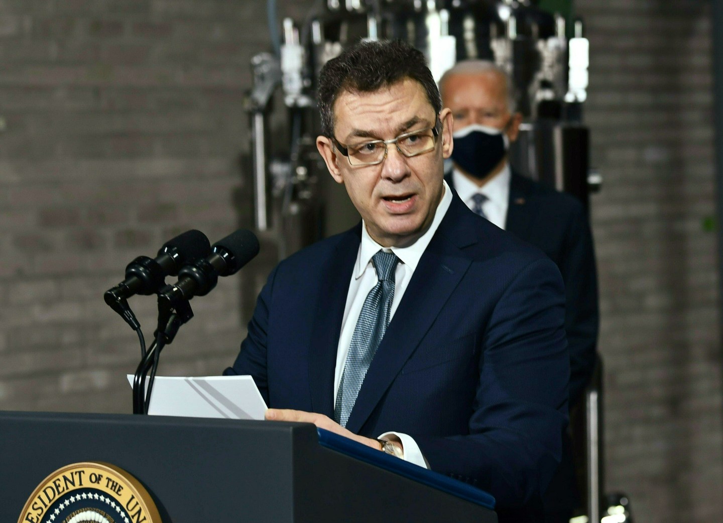 US President Joe Biden listens to Pfizer CEO Albert Bourla speak at the Pfizer Kalamazoo Manufacturing Site February 19, 2021, in Portage, Michigan.