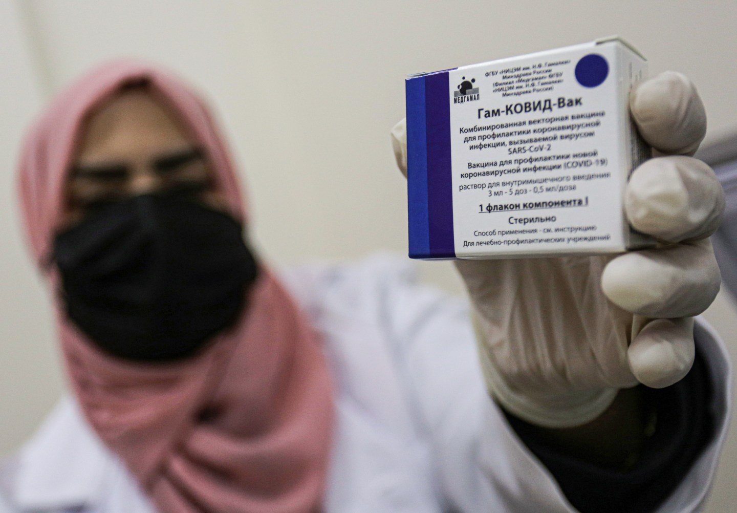 A Palestinian health worker displays the package of the Russian Sputnik V vaccine against the Coronavirus in Khan Yunis, south of the Gaza Strip. About 20,000 doses of the Russian Sputnik V vaccine arrived from the United Arab Emirates in the Gaza Strip.