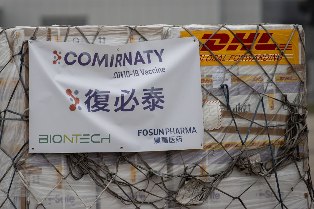 Refrigerated shipping containers carrying the BioNTech vaccine, imported by Fosun Pharma, in transport at the Hong Kong International Airport, Feb. 25, 2021.