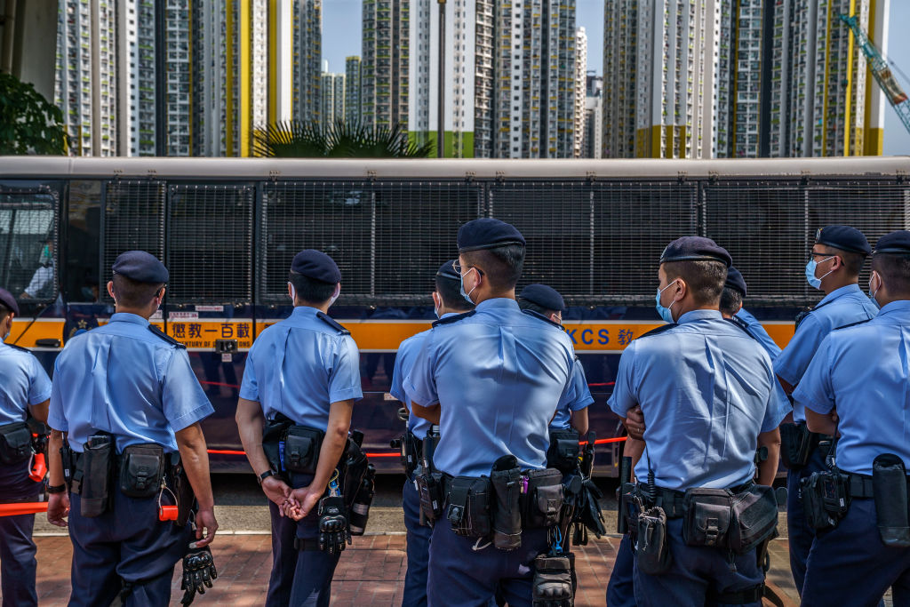 Police stand guard outside West Kowloon Magistrates’ Courts, where bail hearings for 47 democracy activists charged under Hong Kong’s National Security Law have stretched over four days.