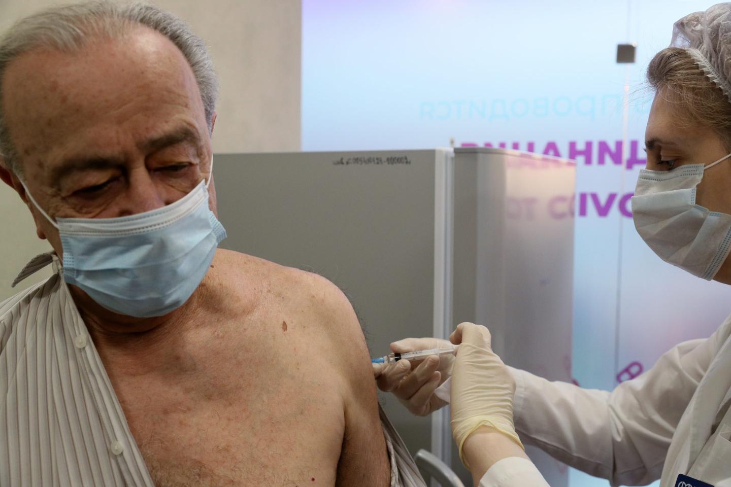 A man is vaccinated with the Gam-COVID-Vac (Sputnik V) COVID-19 vaccine at a mobile vaccination site at the Rio shopping center in Moscow, on March 3.