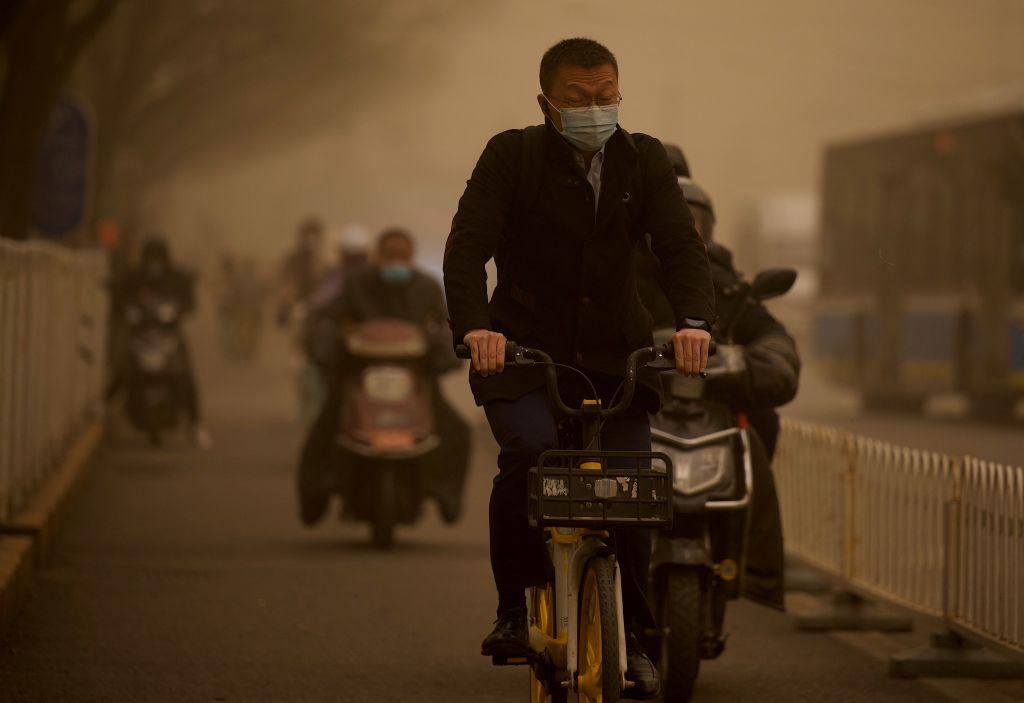 Beijing warns residents to avoid outdoor activity as a massive sandstorm covers the capital in yellow dust