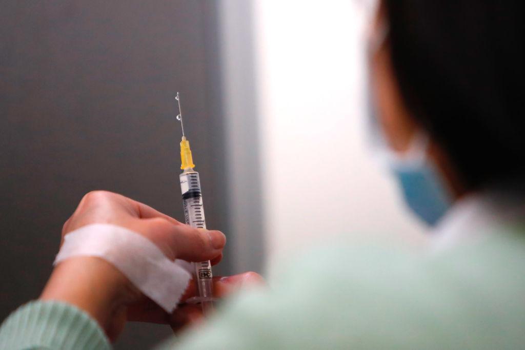 A nurse prepares a dose of AstraZeneca vaccine against Covid