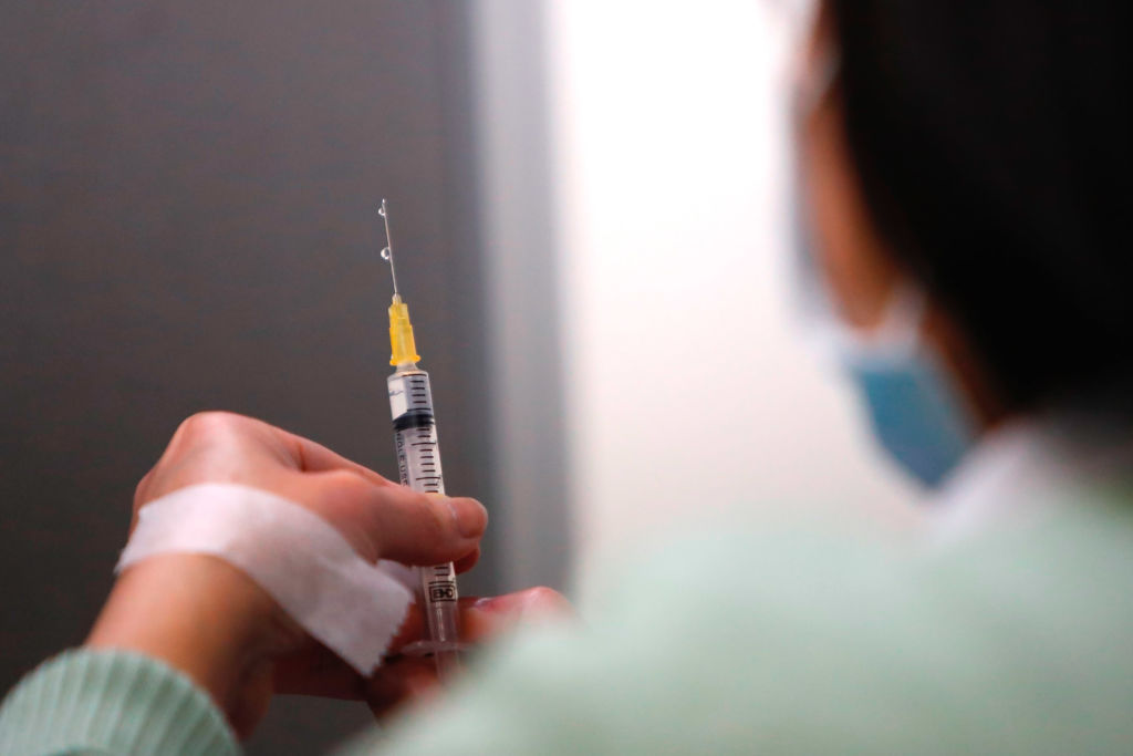 A nurse prepares a dose of AstraZeneca vaccine against Covid