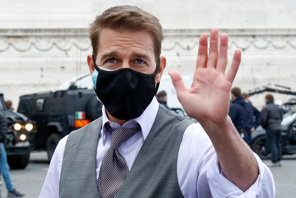 Picture of Tom Cruise wearing a face mask and waving during filming of the latest Mission Impossible movie in Rome.