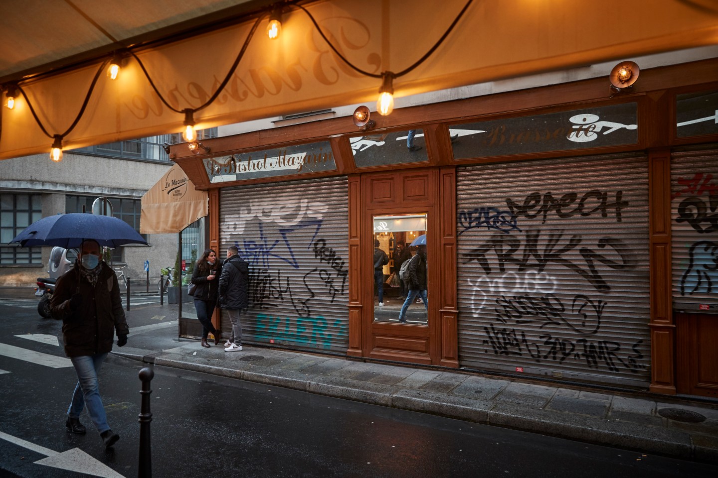 Parisians drink in front of a closed Bistro on March 18, 2021 in Paris, France.