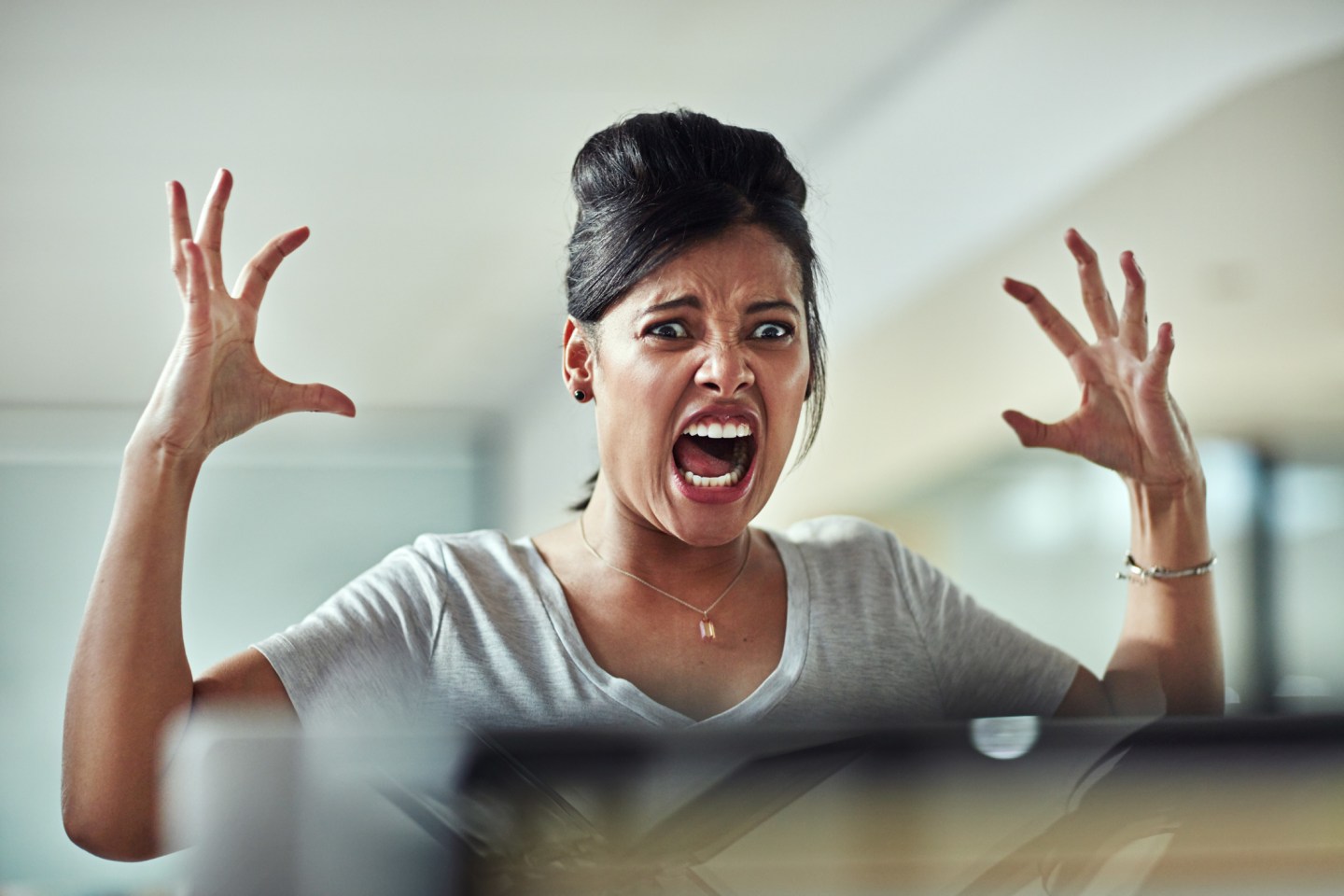 Shot of a frazzled young businesswoman freaking out in the office