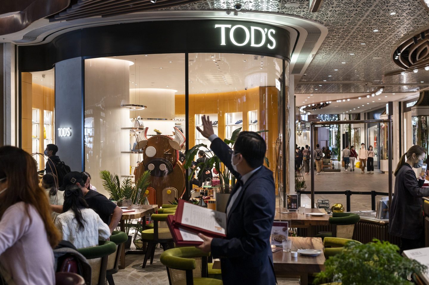 HONG KONG, CHINA - 2021/03/23: Shoppers seen walking past the Italian luxury shoes and leather goods brand Tod's store at a shopping mall in Hong Kong. (Photo by Budrul Chukrut/SOPA Images/LightRocket via Getty Images)