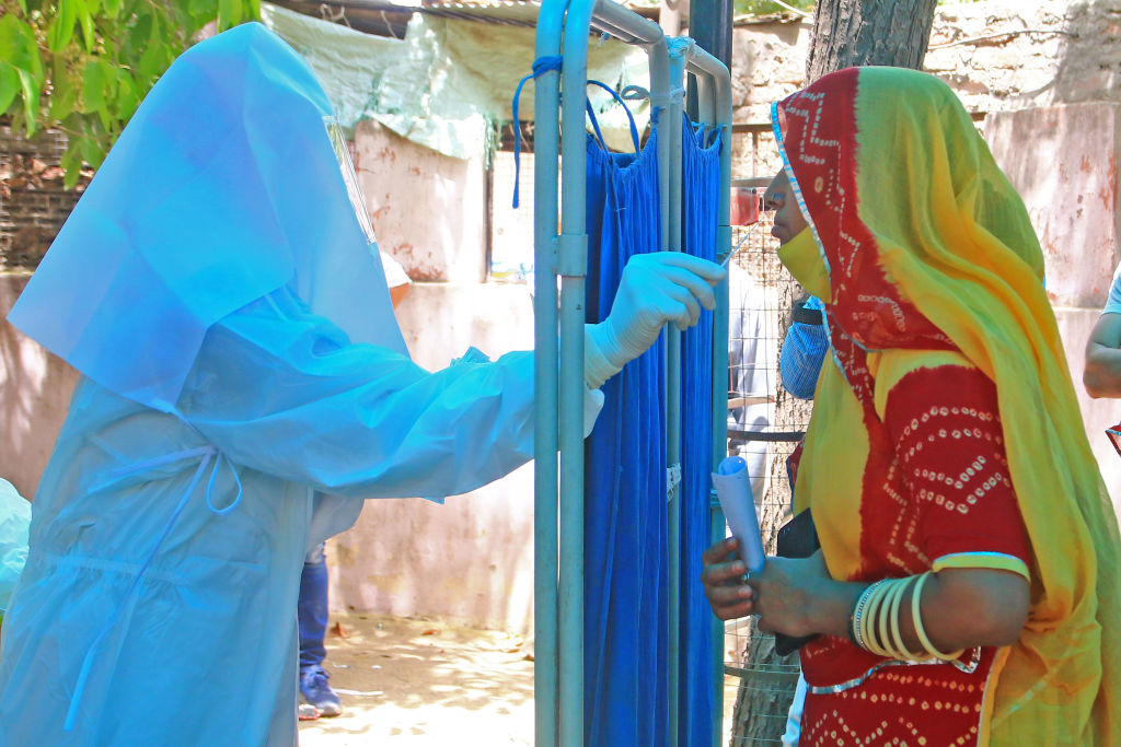 As coronavirus cases surge across India, a health worker administers a COVID-19 test at a hospital in Jaipur, Rajasthan, on April 6, 2021.