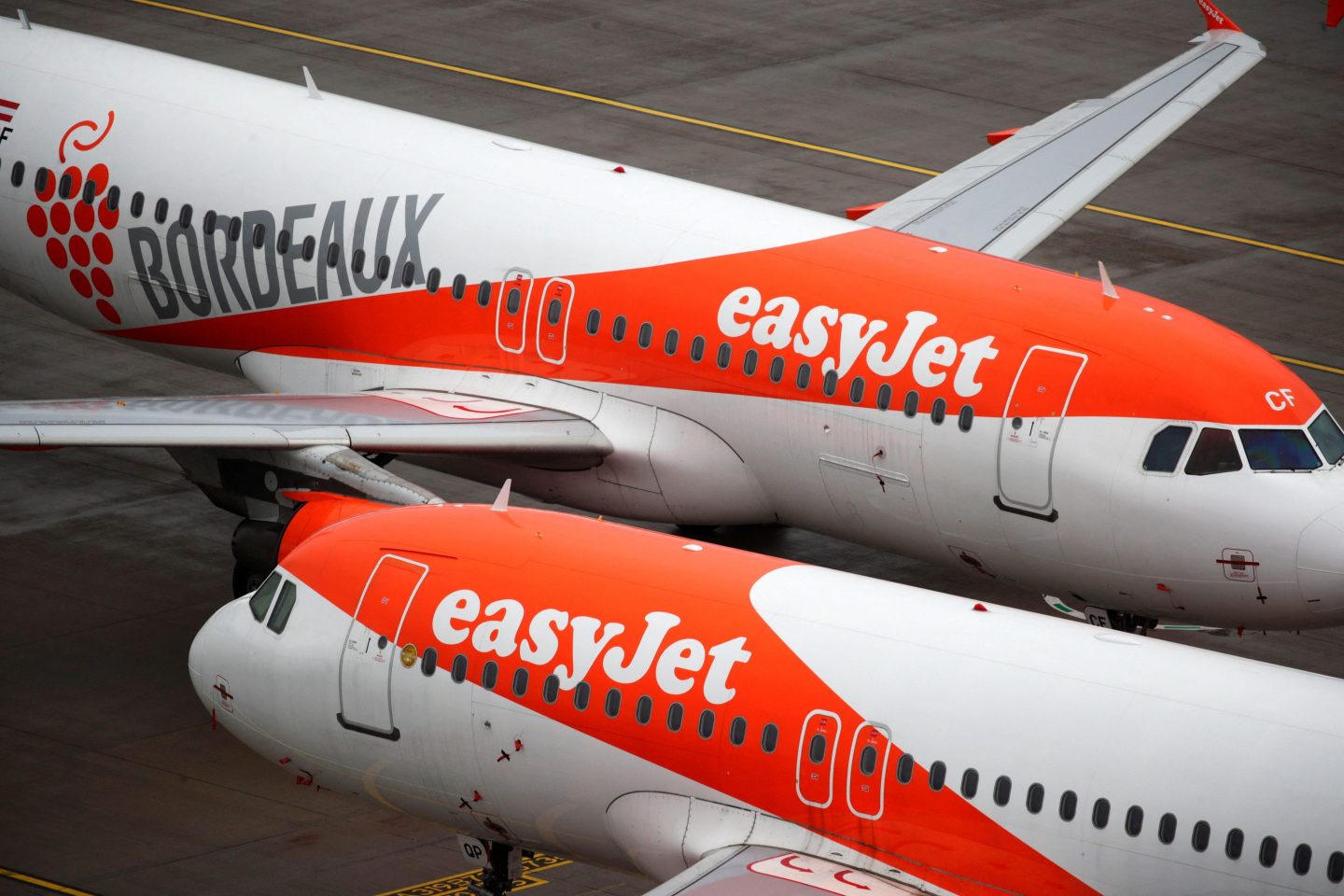 EasyJet airplanes parked on the tarmac during the official opening of Berlin Brandenburg Airport on Oct. 31, 2020. The airline has differentiated itself from other budget carriers by serving top-tier European airports. But the strategy also burdens EasyJet with higher costs as it tries to recover from the pandemic.