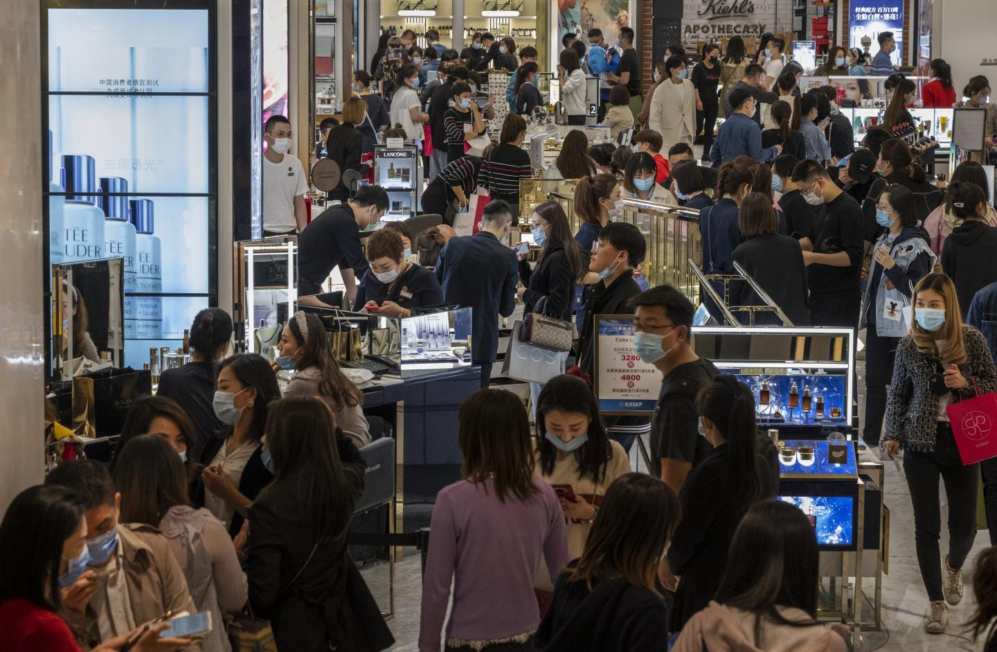 Shoppers and staff in a mall in Beijing in April 2021. “Income growth is likely to accelerate as the impact of COVID recedes further,” writes Andy Rothman.