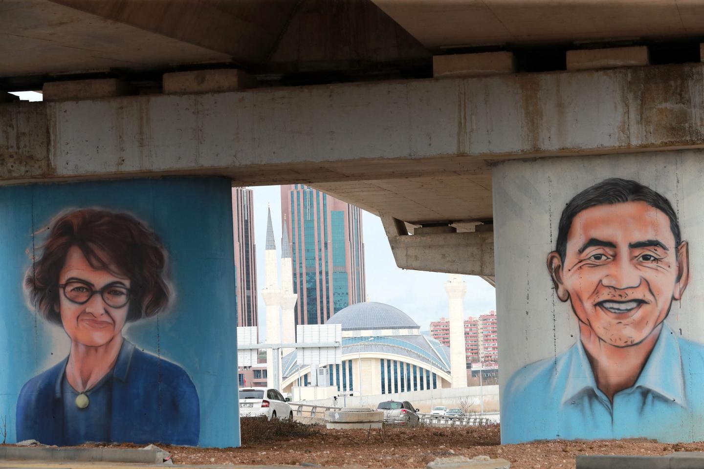Ankara's Metropolitan Municipality paid tribute to Ozlem Tureci (L) and Ugur Sahin (R), the German couple of Turkish origin who are behind the BioNTech firm which developed a successful vaccine with US giant Pfizer, as part of a series of graffiti dedicated to the efforts of healthcare workers during the Covid-19 pandemic in the City Hospital region of the Turkish capital, Ankara on April 19, 2021.