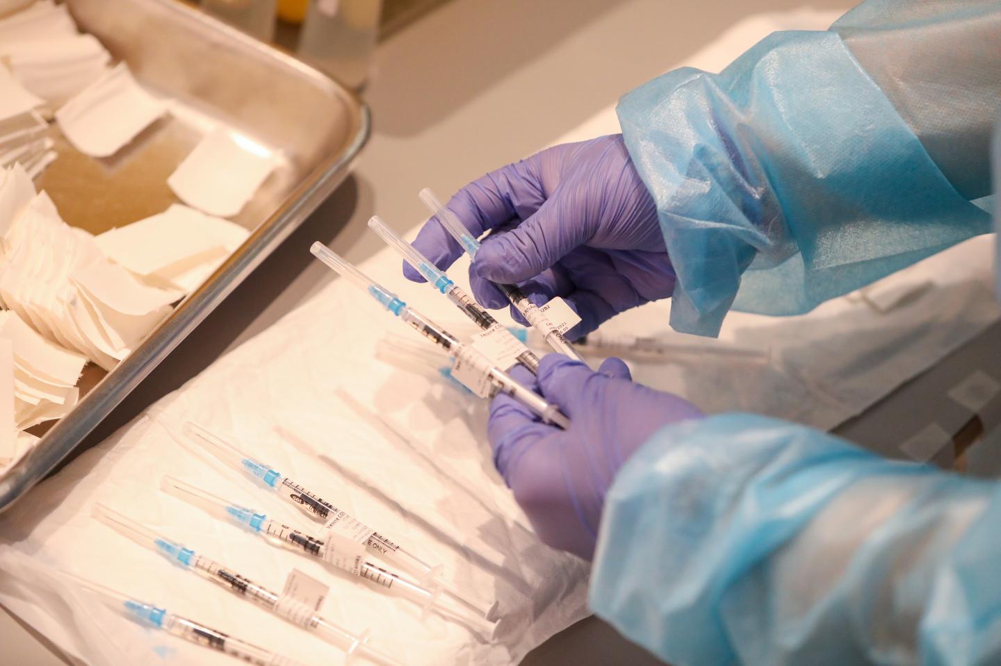 Companies enlist vaccine whisperers to convince skeptical workers to get their jabs