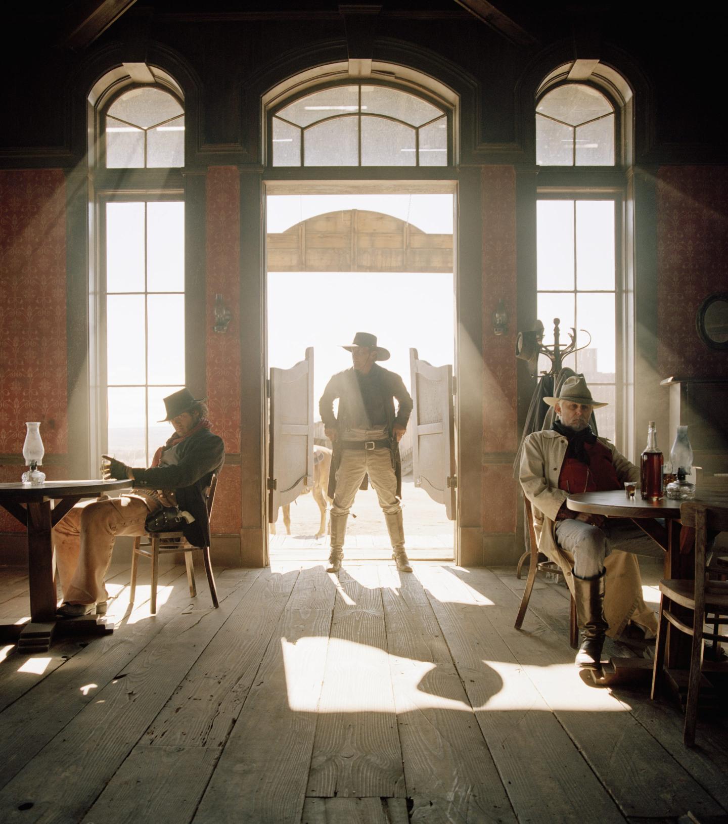 A gun slinger walking into a saloon.