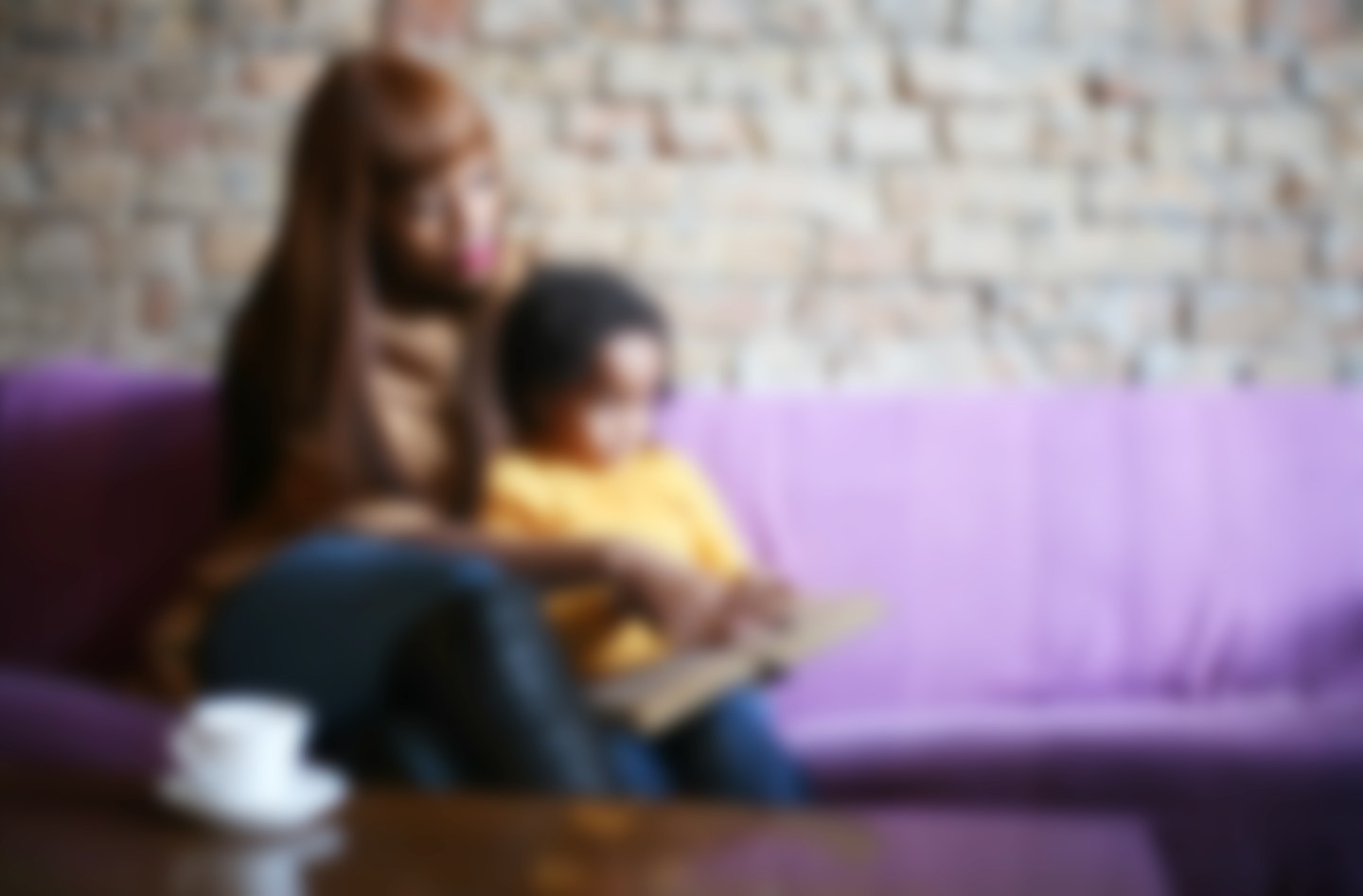 Defocused picture, family reading a book.