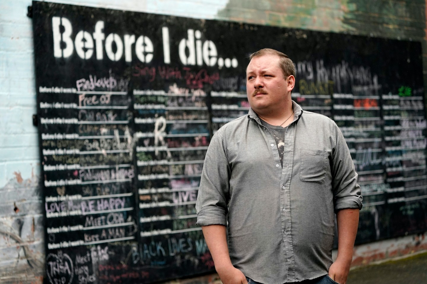Nate Mullins, a former bartender from Oak, Harbor, Wash., who quit his job last November after clashing with managers over enforcing mask rules, poses for a photo near a street mural Monday, May 17, 2021, in Mount Vernon, Wash. There&#8217;s a wild card in the push to return to post-pandemic life: many workers don&#8217;t want to return to the jobs they once had. Mullins&#8217; unemployment checks don&#8217;t match what he was making at the bar, but they&#8217;re enough to get by while he looks for jobs that would provide health care and retirement benefits. (AP Photo/Elaine Thompson)