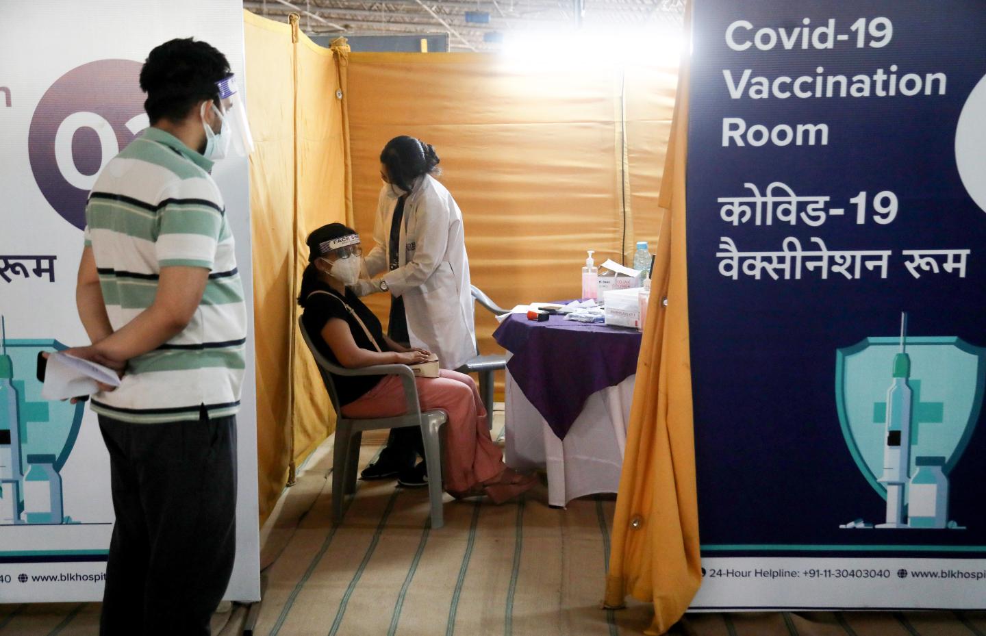 A woman receives the first dose of the Covishield Covid-19 vaccine at Radha Soami Satsang grounds. Radha Soami Satsang grounds have been turned into a vaccination center, which was set up by BLK-MAX hospital in New Delhi. India reported 357,316 fresh coronavirus cases and 3,502 deaths in last 24 hours.