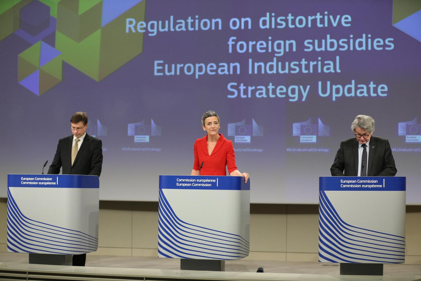 Margrethe Vestager, competition commissioner of the European Commission, center, speaks beside Valdis Dombrovskis, trade commissioner for the European Union (EU), left, and Thierry Breton, industry commissioner of the European Union (EU), during a news conference in Brussels, Belgium, on Wednesday.