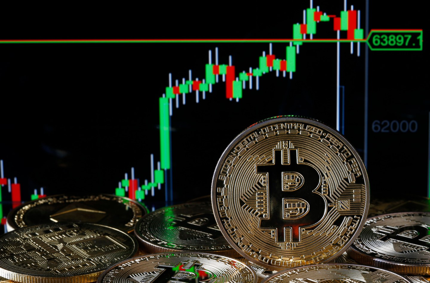 A visual representation of the digital Cryptocurrency, Bitcoin is on display in front of the Bitcoin value graph.