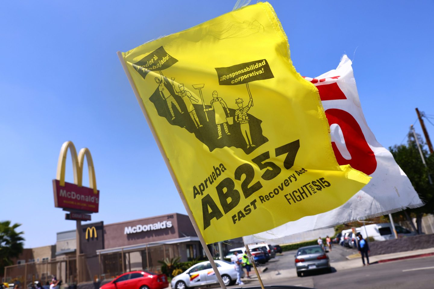 A banner advocating for California's FAST Recovery Act at a rally of fast food workers in Los Angeles in April, 2021. Elements of that bill "could form the backbone of fundamental change in the industry," writes David Madland.