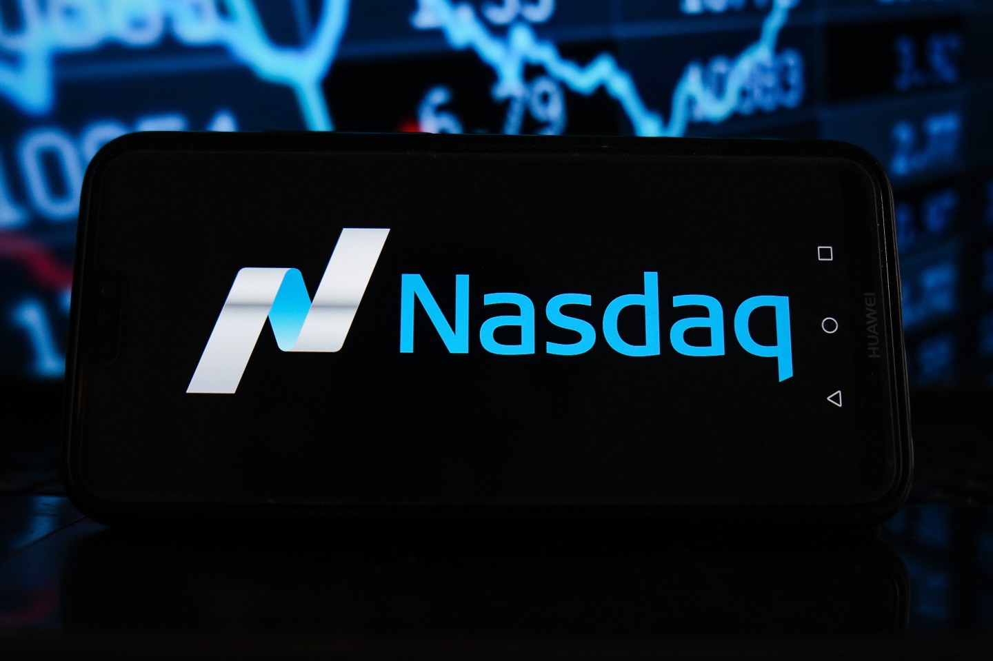 POLAND &#8211; 2021/03/21: In this photo illustration a Nasdaq logo seen displayed on a smartphone with stock market percentages in the background. (Photo Illustration by Omar Marques/SOPA Images/LightRocket via Getty Images)