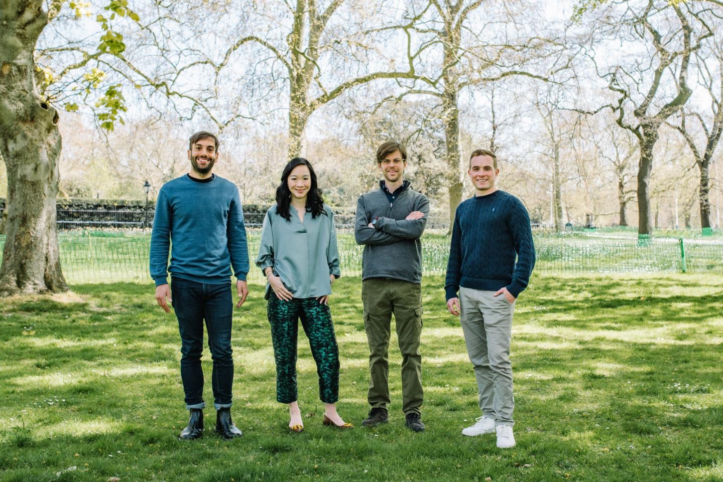 The members of the Moonfire Ventures team posing in a park.