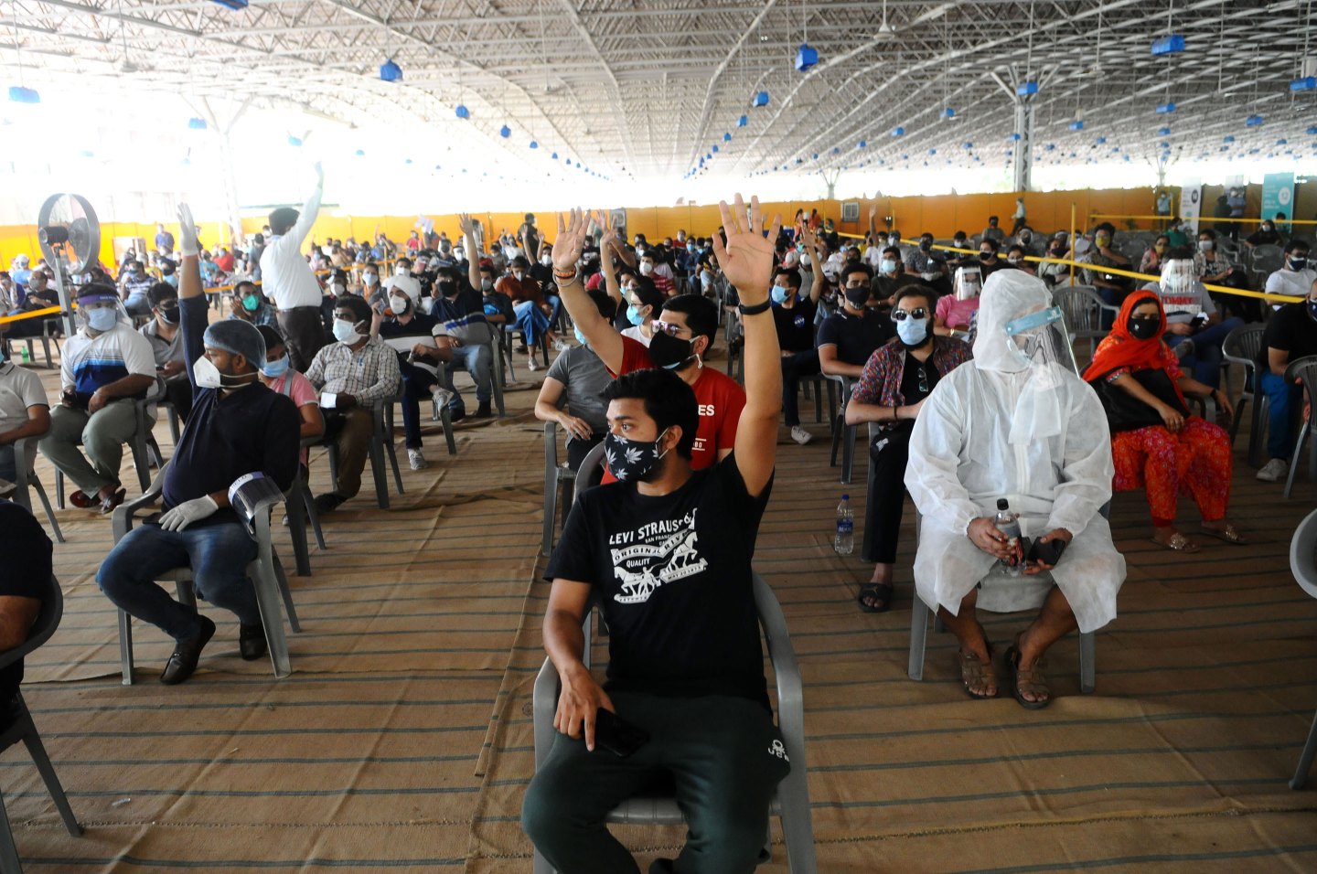 People wait to receive a dose of Covishield, manufactured by the Serum Institute of India, at a vaccination center in New Delhi, on May 4, 2021.