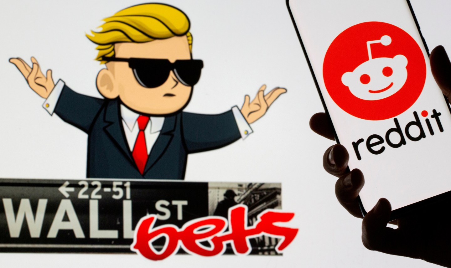 The Reddit logo is seen on a smartphone in front of a displayed Wall Street Bets logo in this illustration