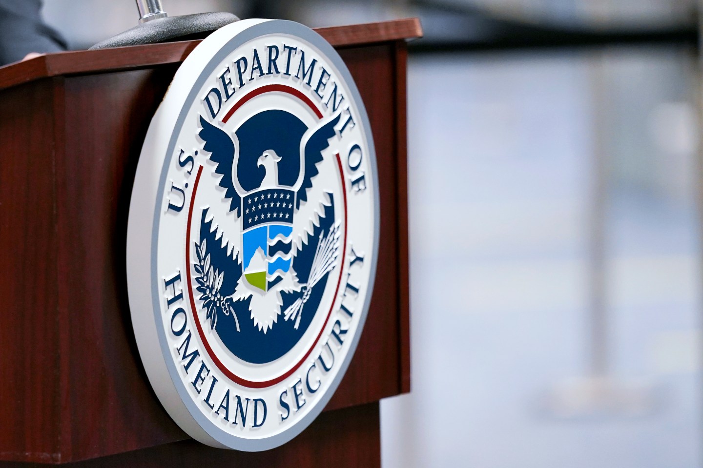 A U.S. Department of Homeland Security plaque is on a podium as international passengers arrive at Miami international Airport where they are screened by U.S. Customs and Border Protection (CBP) using facial biometrics to automate manual document checks required for admission into the U.S. Friday, Nov. 20, 2020, in Miami. Miami International Airport is the latest airport to provide Simplified Arrival airport-wide. (AP Photo/Lynne Sladky)