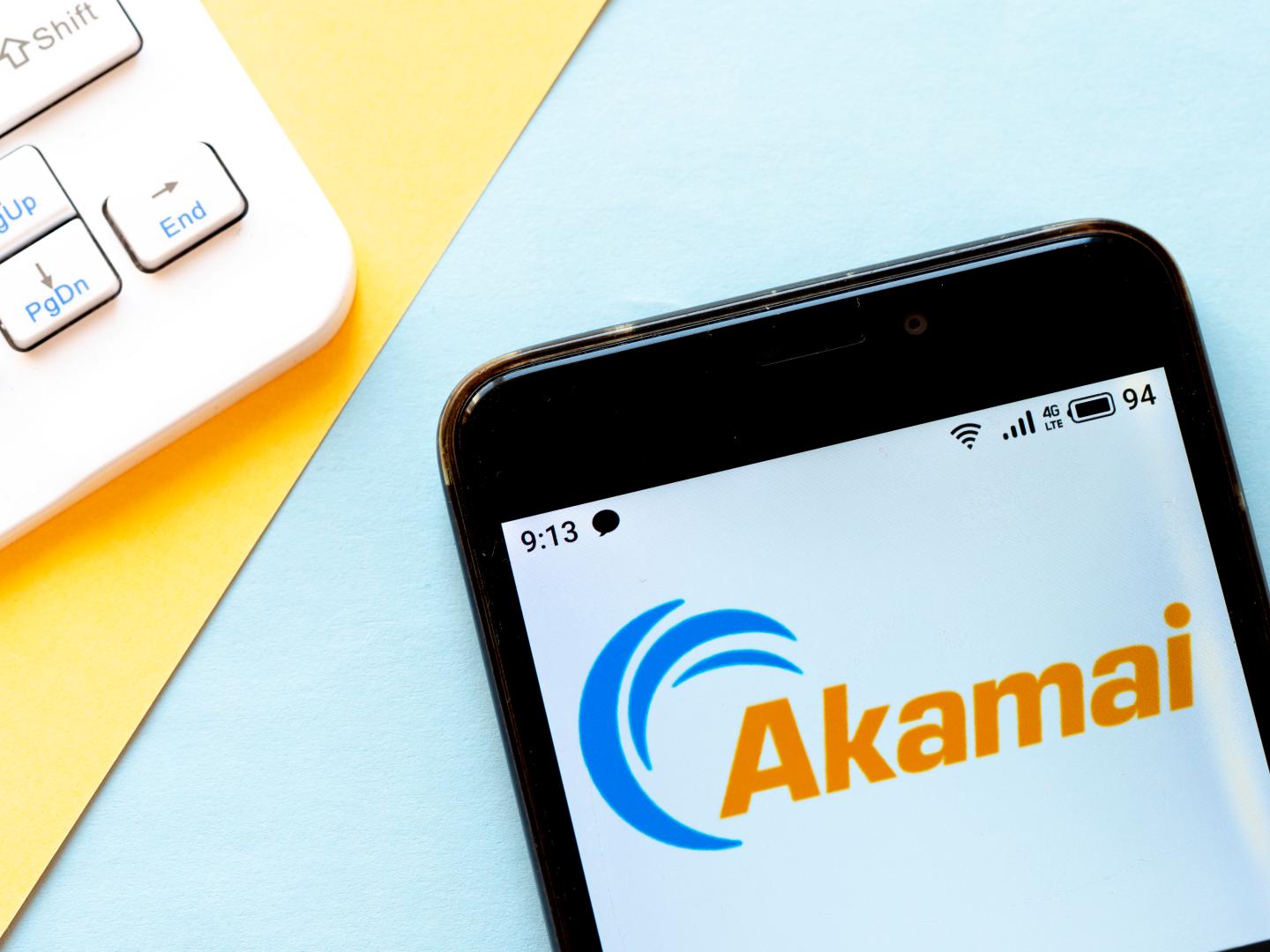 An Akamai logo is seen displayed on a smartphone.