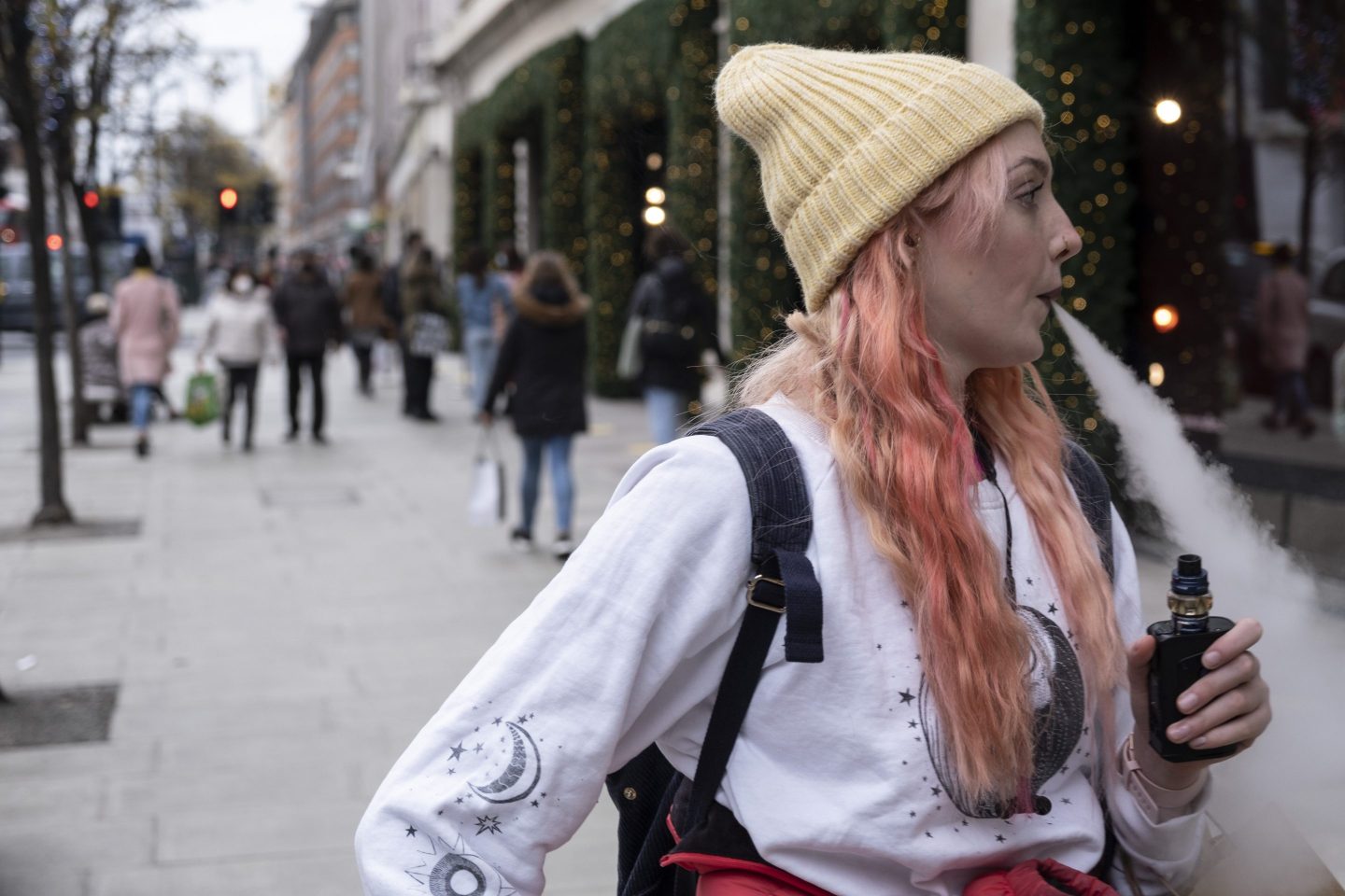 A young woman vaping in London
