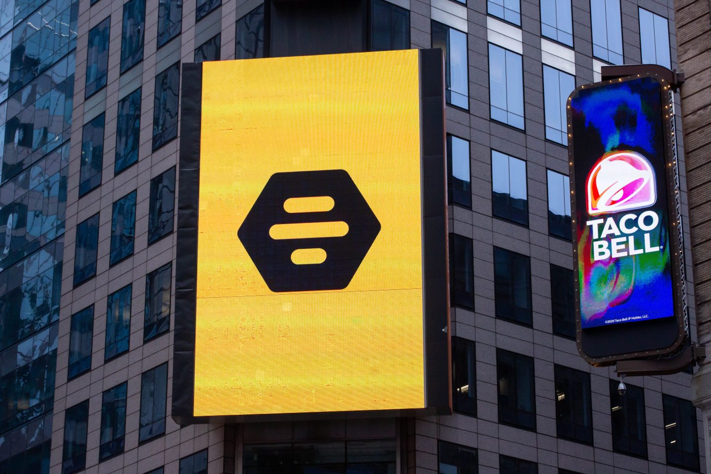 Monitors display Bumble Inc. signage during the company&#8217;s initial public offering (IPO) in front of the Nasdaq MarketSite in New York, U.S., on Thursday, Feb. 11, 2021. Bumble Inc., the dating app where women make the first move, is targeting to raise as much as $1.8 billion from its U.S. initial public offering after boosting the size of the deal. Photographer: Michael Nagle/Bloomberg via Getty Images