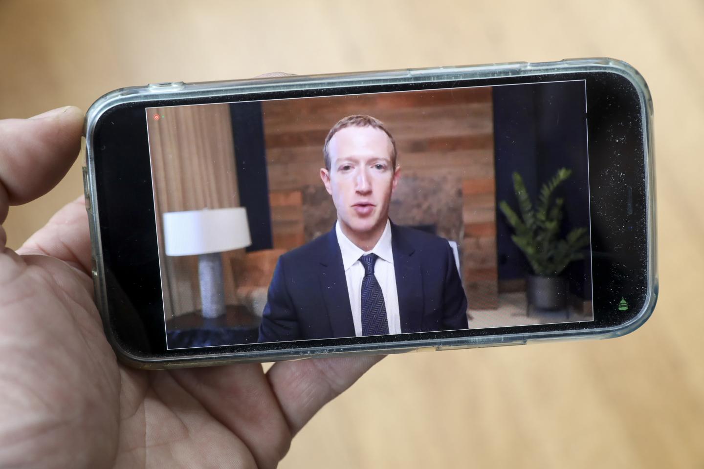 Mark Zuckerberg, chief executive officer of Facebook Inc., speaks virtually during a House Energy and Commerce Subcommittees hearing on a mobile phone in Tiskilwa, Illinois, U.S., on Thursday, March 25, 2021.