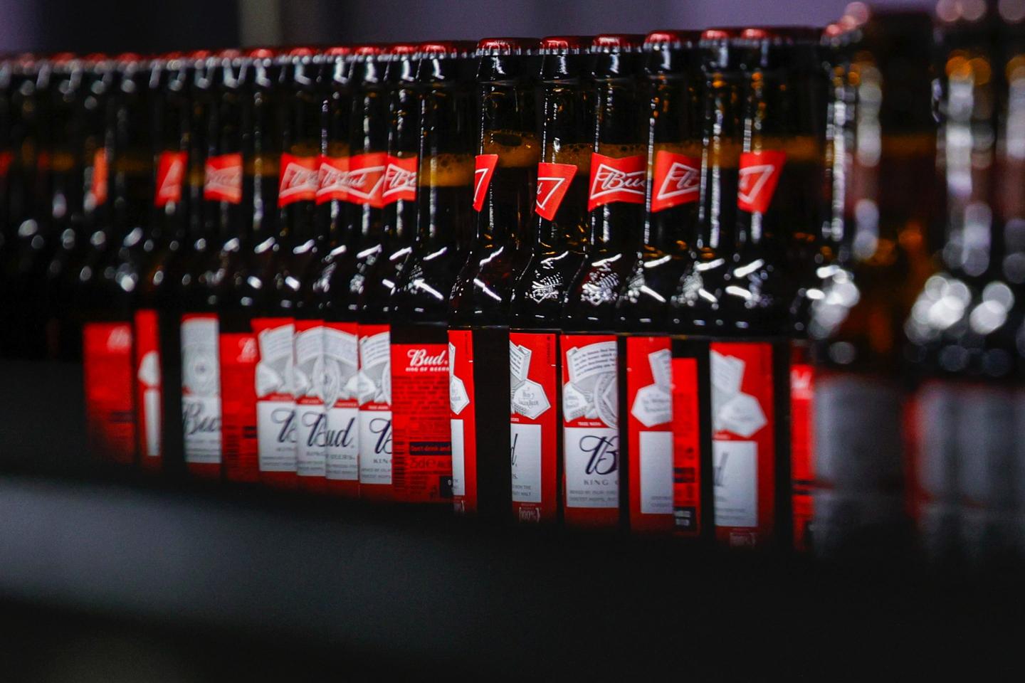 Bottles of Budweiser beer on a conveyor at the Anheuser-Busch InBev NV brewery in Leuven, Belgium