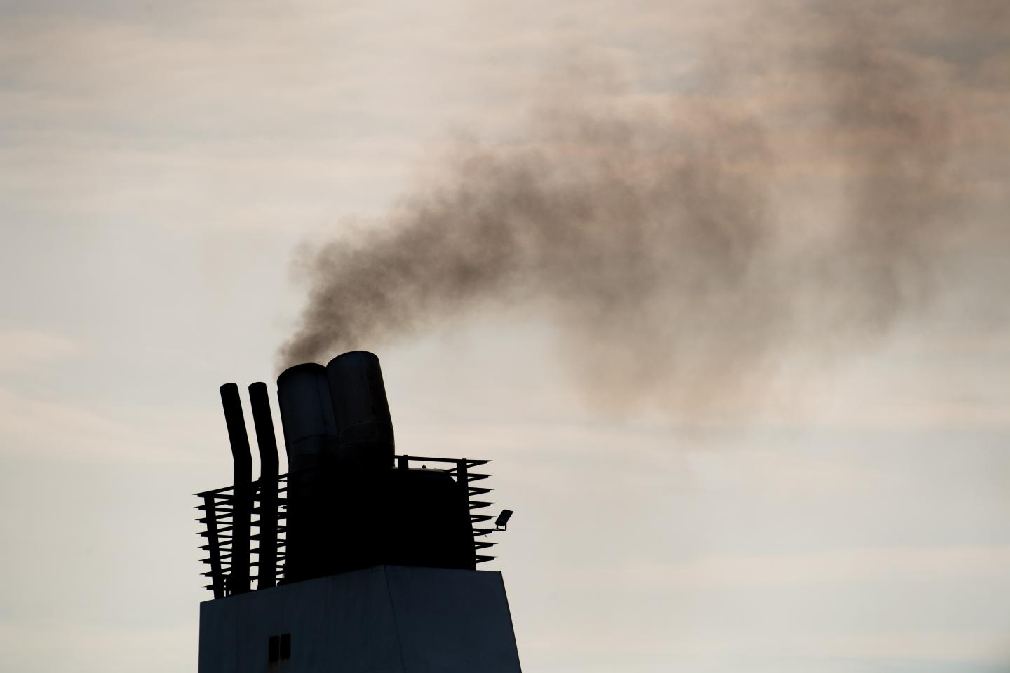 06 June 2021, Schleswig-Holstein, Travemünde: A ferry emits exhaust fumes from a smokestack.