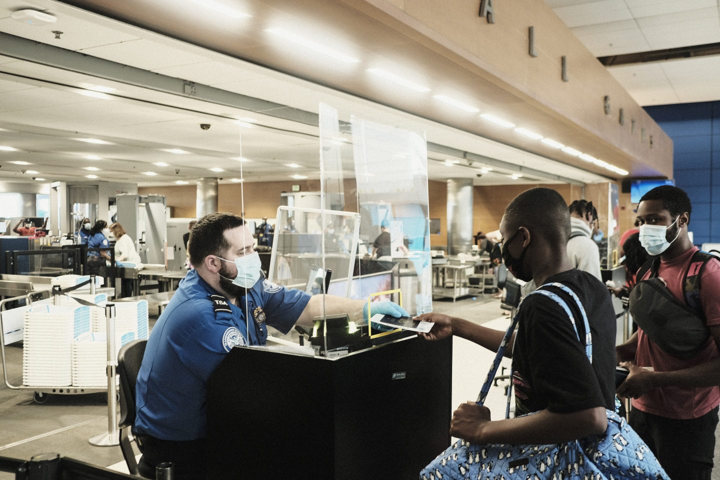 A Transportation Security Administration (TSA) agent screens travelers at a checkpoint in the Detroit Metropolitan Wayne County Airport (DTX) in Romulus, Michigan, U.S., on Saturday, June 12, 2021.