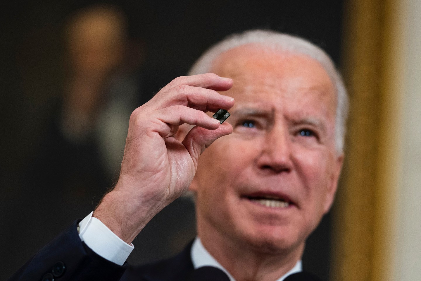President Joe Biden holds a semiconductor during his remarks before signing an Executive Order on the economy in the State Dining Room on Wednesday, Feb. 24, 2021.