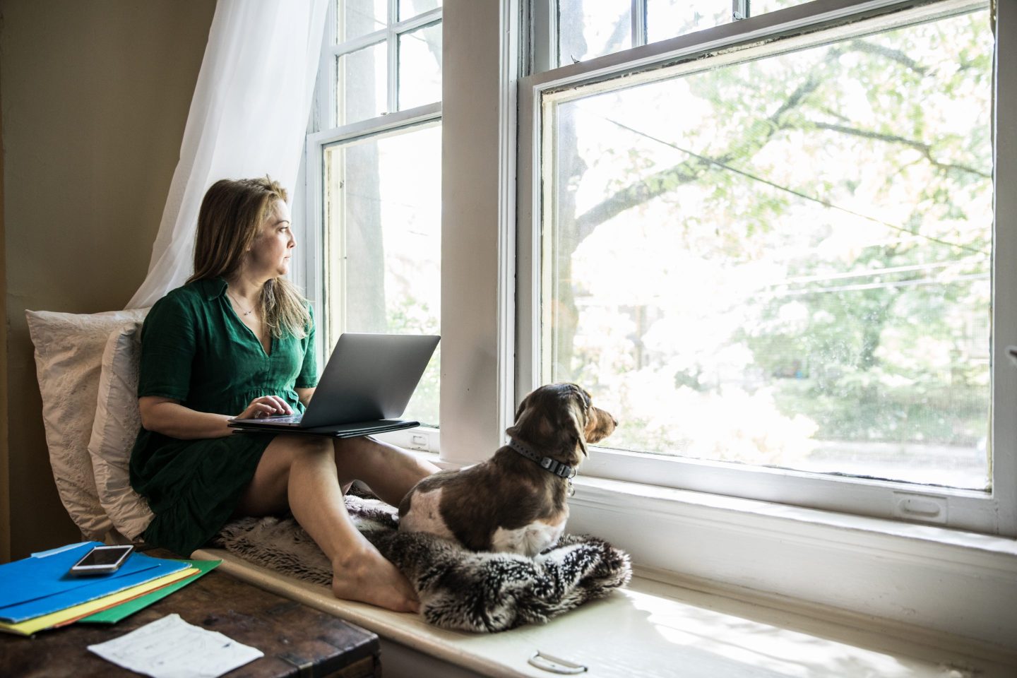 Woman working at home with her dog