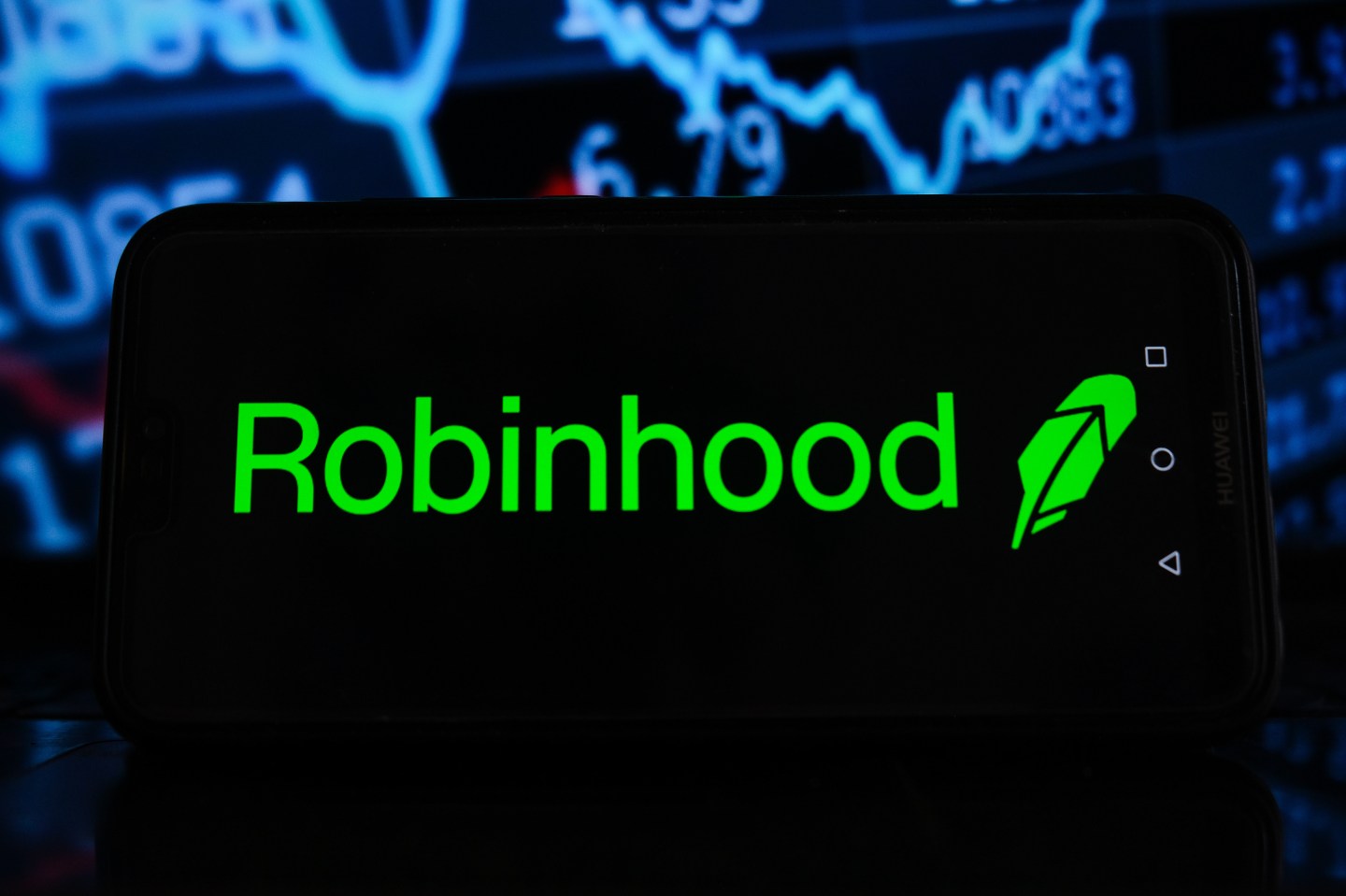 In this photo illustration a Robinhood logo seen displayed on a smartphone with stock market percentages in the background.