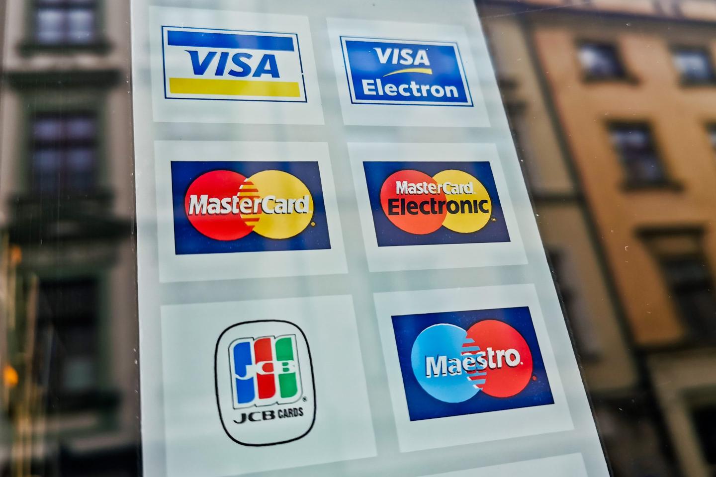 Photo of Visa, Mastercard and other payment cards accepted at an ATM in Poland.